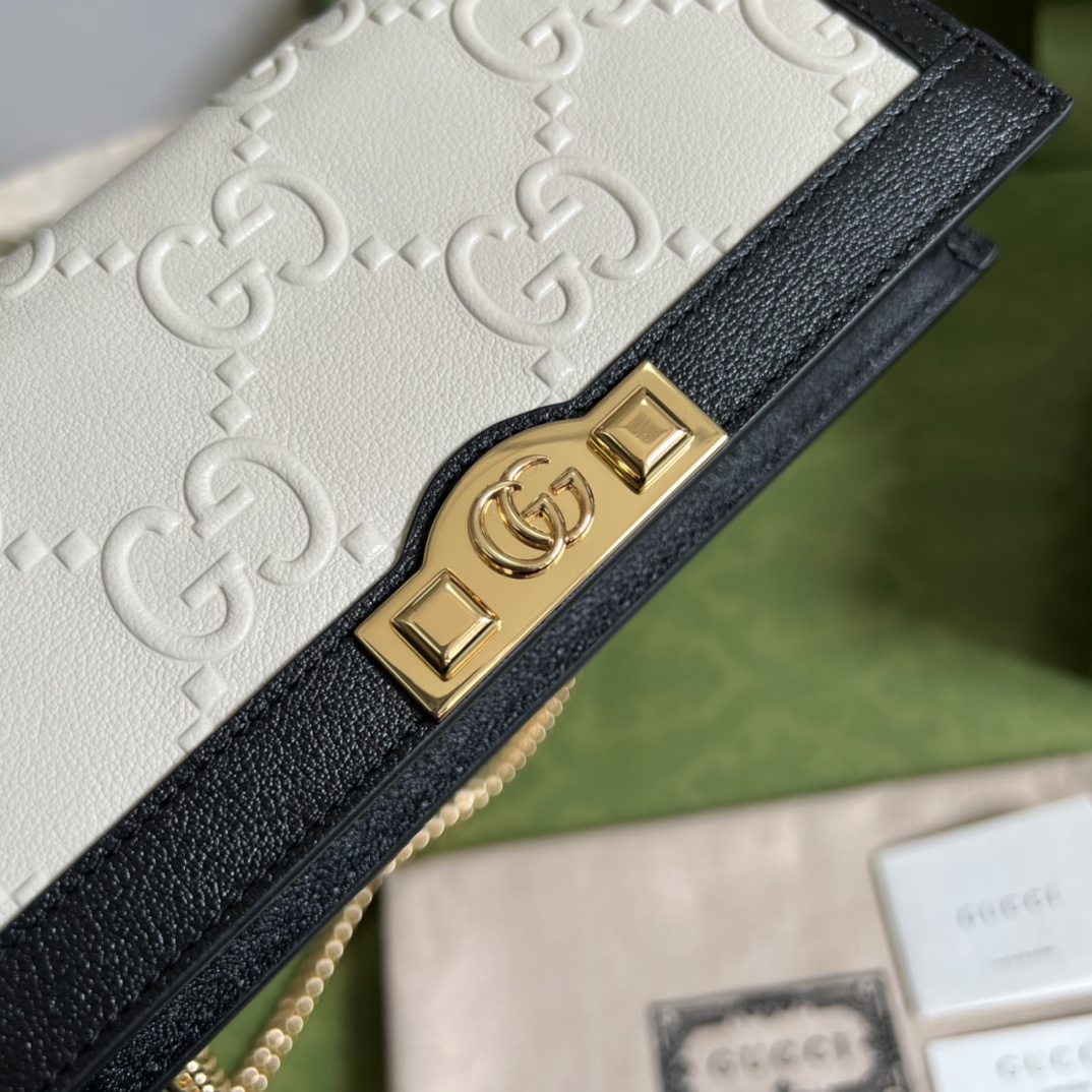 G*u*i leather clutch